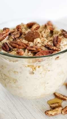 a bowl filled with oatmeal and pecans on top of a table