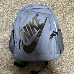 Blue Nike Backpack With Straps And Water Bottle Holder Cheap Nike Black Backpack, Cheap Nike Standard Backpack, Cheap Black Nike Backpack, Cheap Everyday Nike Backpack, Cheap Nike Nylon Backpack, Nike Tanjun Premium Backpack, Nike Backpack For Back To School, Nike Backpack For Daily Use Back To School, Nike Backpack For Travel And Back To School