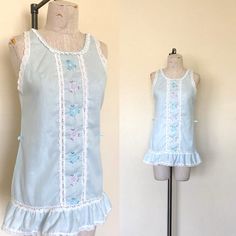 "- Vintage 1980's era lace and embroidered sleeveless nightie  - Fabric label is unreadable, Feels like a super lightweight cotton woven - Light blue with white lace trim around neckline, armholes, bottom edge, and down center front on both sides of embroidery - Pink and light blue flowers embroidered down center fornt - Ruffled edge on bottom - Back side is plain - Waist has two belt loops at side seam  SIZE: Label says Petite, Fits like a Small/Medium LABEL: Gilead MEASUREMENTS: Chest 36\", Wa Flowers Embroidered, Long Sleeve Cocktail Dress, Light Blue Flowers, Lace Sleeveless Top, 1980s Dresses, Fabric Labels, Denim And Lace, Navy Lace, Size Label