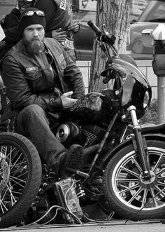 a black and white photo of a man sitting on a motorcycle with the caption, ryan hurst as opie my favorite c