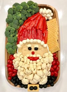 a santa clause made out of vegetables and crackers