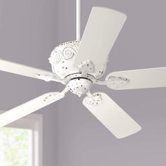 a white ceiling fan in a room