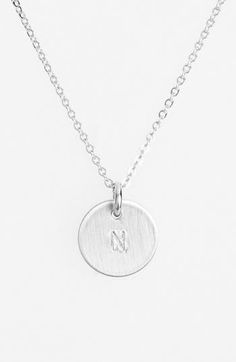 From humble beginnings to a fully staffed warehouse in Bend, Oregon, Nashelle remains true to its original purpose—handmade jewelry crafted with love and intention. The mini-initial necklace is no different, with a small hand-stamped pendant suspended from a delicate chain for a dainty effect. Add additional charms to customize your necklace with our selection of Nashelle charms and chains. 17 1/2" length. 3/8" pendant drop. Spring-ring closure. Sterling silver. By Nashelle; made in the USA. Everyday Hand Stamped Initial Pendant Necklace, Hand Stamped Minimalist Pendant Necklace, Minimalist Hand Stamped Pendant Necklace, Classic Everyday Nickel-free Necklaces, Classic Adjustable Initials Necklace, Minimalist Hand Stamped Initial Necklace For Everyday, Minimalist Hand Stamped Round Pendant Necklace, Minimalist Hand Stamped Initial Necklace, Minimalist Everyday Hand Stamped Initial Necklace