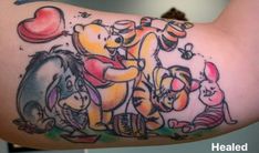 winnie the pooh tattoo on someone's arm