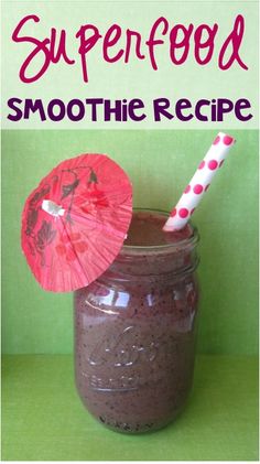 a smoothie in a mason jar with an umbrella on the top and text superfood smoothie recipe