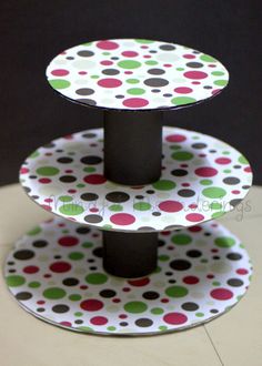 three tiered cake stand with polka dots on it