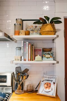 the kitchen counter is covered with books and cooking utensils