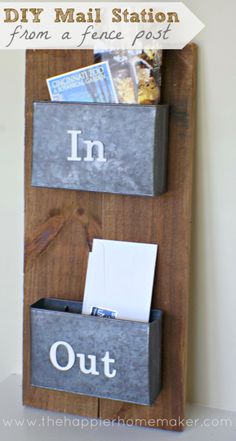 a diy mail station made out of an old door and some metal bins