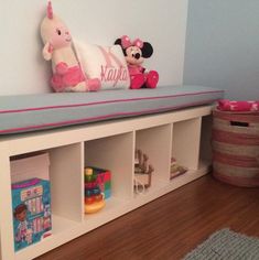 there is a stuffed animal sitting on top of the bookcases in this child's room