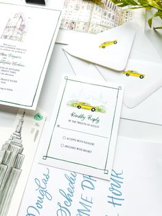 the wedding stationery is laid out on top of the envelopes and cards, which are decorated with blue ink