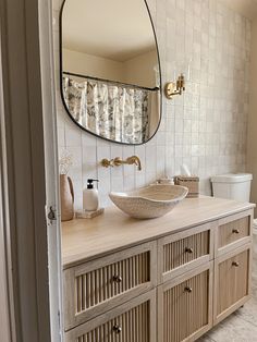 a bathroom with a sink, mirror and toilet