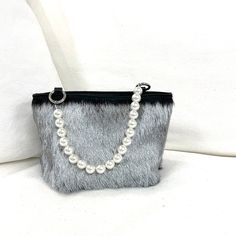 DESCRIPTION:Make a statement and get noticed with our new Fiona Handbag! Unique genuine fur bracelet handbag with pearl handle. Carry on your arm for hands free or hold in your hand. Fully lined with inner pocket. Fun and versatile to dress up a sleek black dress or dress down w jeans and a simple t-shirt; completing your look on an afternoon or night out - even at a wedding! Holds a cell, money, credit cards, glasses, lipstick, keys. • Genuine Italian short fur, Olive Sheepskin or long curly Mo Chic Evening Shoulder Bag With Faux Fur Lining, Elegant Evening Shoulder Bag With Faux Fur Lining, Chic Shoulder Bag With Faux Fur Trim For Everyday, Elegant Evening Bags With Faux Fur Lining, Silver Handheld Bag With Pearl Handle, Elegant Rectangular Shoulder Bag With Faux Fur Lining, Black Handheld Bag With Pearl Handle, Rectangular Faux Fur Bag With Fur Lining, Elegant Rectangular Faux Fur Bag