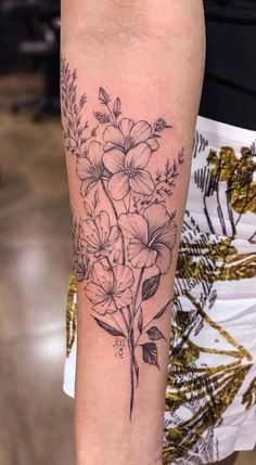 a black and white flower tattoo on the arm