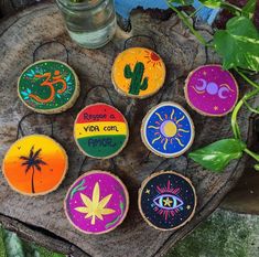 decorated cookies sitting on top of a tree stump