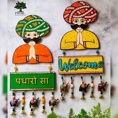 two colorful welcome signs hanging from the side of a wall