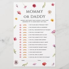 a baby shower game with flowers on the front and back, which reads mommy or daddy