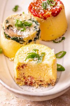 three different types of desserts on a white plate with green garnishes