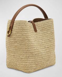 a straw bag with leather handles