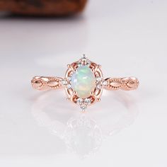 Gorgeous vintage inspired Australian opal ring ✧ Sterling silver (925) or 14K Gold or 14K Rose gold ✧ Accented with natural quartz diamonds This gorgeous, timeless ring features a stunning Australian opal and natural crystals. ✧ Stone: Natural Gemstone  ✧ Shape: Oval ✧ Carat Weight: 0.53ct. (approx.) ✧ Gemstone Origin: Australia  ✧ Sizes 2.75-12.25 ✧ This ring set will arrive ready to gift in a Kherish Box. ✧ Due to the nature of the handmade process, each piece may slightly vary in color, size, Heirloom Rose Gold Opal Ring Gift, Heirloom Rose Gold Oval Opal Ring, Oval Rose Gold Opal Ring For Anniversary, Heirloom Style Rose Gold Opal Ring For Anniversary, Rose Gold Opal Ring With Halo Setting For Anniversary, Vintage Opal Ring, Opal Ring Vintage, Rose Gold Opal Ring, Australian Opal Ring