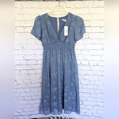 Baltic Born June Smocked Midi Dress Dusty Blue Size S Nwt Blue Knee-length Midi Dress With Smocked Back, Blue V-neck Midi Dress With Smocked Bodice, Blue Dress With Fitted Waist For Spring, Casual Flowy Mid-length Smocked Dress, Blue V-neck Dress With Fitted Waist, Blue Smocked Dress With Short Sleeves For Spring, Blue Knee-length Smocked Dress For Spring, Light Blue Fitted Smocked Dress With Short Sleeves, Blue Short Sleeve Smocked Dress For Spring