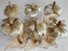 there are many decorative flowers made out of sticks and pinecone cones on top of each other