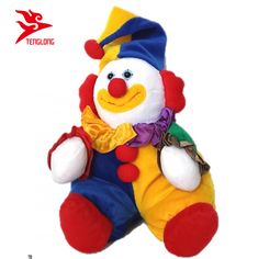 a stuffed toy clown sitting up against a white background