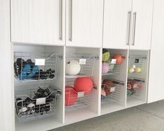 the cabinets are organized with baskets and balls