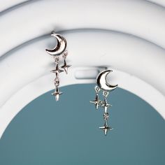 These cute dainty moon and stars stud earrings features a cute crescent moon and a trail of stars drop, made of solid 925 sterling silver and platinum plating. Add these elegant moon and stars stud drop earrings to your everyday fine jewelry collection or as a gift for your love one. Material: sterling silverFinish: platinum plateDimensions: 0.76 x 0.27 in Jewelry Care: See more information about how to care for your jewelry here. Shipping Policy: Orders will be shipped within 1-3 business days. Silver Moon Jewelry, Moon Earrings Aesthetic, Moon Jewelry Silver, Silver Jewellery Aesthetic, Moon Earrings Silver, October Jewelry, Moon With Stars, Lunar Jewelry, Stud Drop Earrings