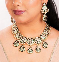 Stunning Kundan and Polki jewelry set inspired by the iconic designs of Sabyasachi Jewelry. This set made with Uncut Polki adorned is an exquisite Green Kundan Necklace featuring intricate Jadau Kundan work. This Pakistani Jewelry is a perfect choice for a bridal ensemble. The set also includes complementary pieces like a Kundan Bridal Set, This is a complete Necklace set with matching earrings and a tikka.  *𝐏𝐑𝐎𝐃𝐔𝐂𝐓 𝐃𝐄𝐓𝐀𝐈𝐋* *    Material:  Brass  *    Plating:  Gold Plated *    Stone:  Semi Precious Kundan & Polki. *DIMENSIONS * Necklace * Weight: 127 gm * Drop Length: 6 Inches * Width: 2.5 Inches Earrings * Weight: 19 gm each * Width: 1.25  inches * Length: 2.8 Inches * Closure : Push Back Tikka *  Weight: 15 gm.  *  Length: 1.3 Inches *  Width: 1.25 Inches *  Top Chain Leng Ceremonial Temple Jewelry With Motifs, Round Kundan Necklace With Meenakari, Temple Jewelry With Motifs For Diwali, Ceremonial Kundan Jewelry With Motifs, Ceremonial Jewelry With Chandbali Motifs, Traditional Green Jewelry With Motifs, Festive Ceremonial Jewelry With Motifs, Kundan Jewelry With Motifs As Gift, Round Temple Jewelry With Motifs