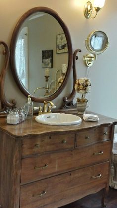 an old dresser with a mirror on it