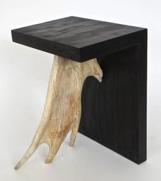 a table made out of wood with a black top and wooden legs on the side