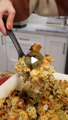 a person scooping food out of a casserole dish