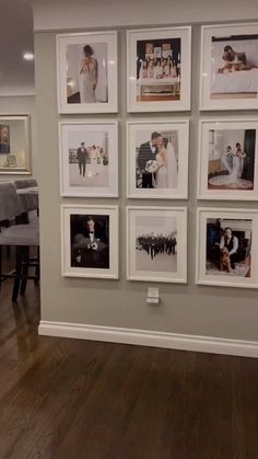 a living room with pictures hanging on the wall