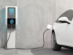 an electric car plugged into a charger in front of a wall with concrete walls