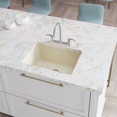 a kitchen sink sitting on top of a white counter