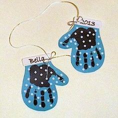 two handprinted blue and black mitts with name tags