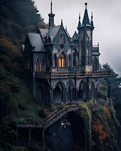 an old castle on top of a cliff in the middle of the forest with stairs leading up to it