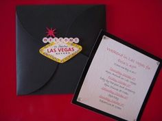 a black envelope with a las vegas sign on it and a card attached to the front