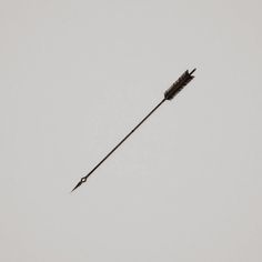 an arrow shaped object flying in the sky