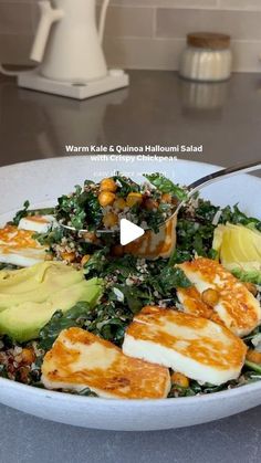 a white bowl filled with food on top of a table