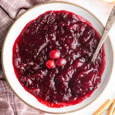 the best homemade cranberry sauce in a bowl with cinnamon sticks and grapefruit