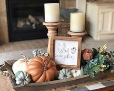 a table with candles and pumpkins on it