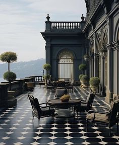 an outdoor patio with black and white tiles