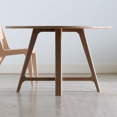 a wooden table with two chairs next to it