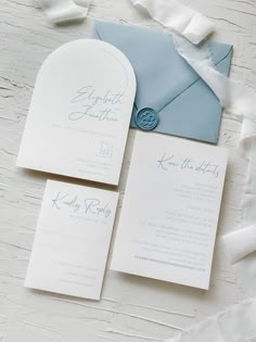 a blue and white wedding suite with an envelope