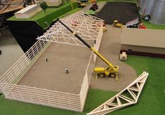 an aerial view of a model farm with trucks and tractors