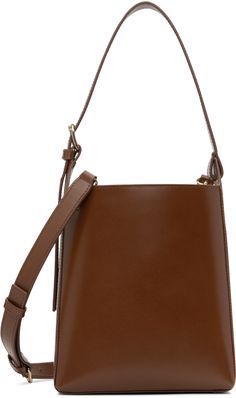 Buffed leather shoulder bag in brown. · Adjustable carry handle · Adjustable and detachable crossbody strap · Logo embossed at side · Patch pocket at interior · Removable drawstring pouch at interior · Full cotton twill lining · H8.25 x W7 x D4.5 Supplier color: Hazelnut Brown Bucket Bag With Detachable Strap, Modern Brown Bucket Bag With Detachable Handle, Brown Bucket Bag With Top Handle And Pouch, Modern Brown Bucket Bag With Adjustable Strap, Brown Bucket Bag With Detachable Strap For Office, Brown Bucket Shoulder Bag With Detachable Handle, Brown Crossbody Bucket Bag With Detachable Handle, Modern Brown Bucket Bag With Detachable Strap, Brown Business Bucket Bag With Adjustable Strap