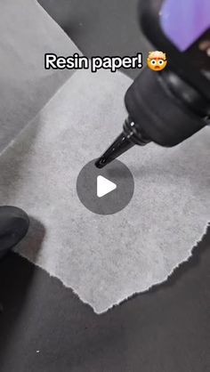 a person using a drill to make a piece of paper