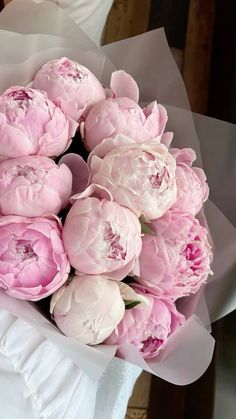 a bouquet of pink flowers sitting on top of a table