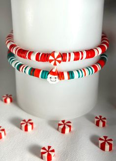 Adorable Christmas Heishi Bracelet! -Choice of Red/White or Green/ Red/ White Heishi Beads and Santa or Peppermint (Mint) Swirl Clay Bead. -Listing is for ONE bracelet. Picture is to reflect bracelet options. -IMPORTANT! Please see wrist measurement instructions in pictures.  Add approximately .50 (a half) inch to your wrist size when you select your bracelet size for most accurate sizing. This is a little different than other bracelets so be sure to pick the correct size based on how you want t Christmas Clay Bracelet Ideas, White Adjustable Beaded Bracelets For Holidays, Adjustable White Beaded Bracelets For Holiday, White Adjustable Jewelry For Christmas, White Christmas Jewelry For Holidays, White Christmas Jewelry For Festive Occasion, White Christmas Jewelry For Festive Season, White Festive Jewelry For Christmas, Handmade White Holiday Jewelry